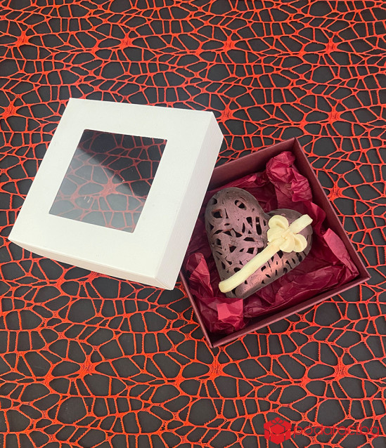 A box with a lace chocolate heart