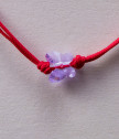 Детска гривна с червен конец и лилава пеперуда